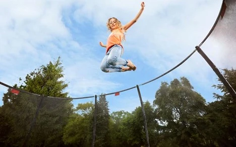 child-mid-air-jumping-on-a-trampoline